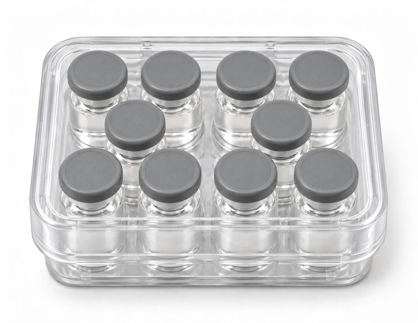 Packaging illustration: ten unlabelled glass vials with gray caps in a compact clear plastic kit case with its lid closed