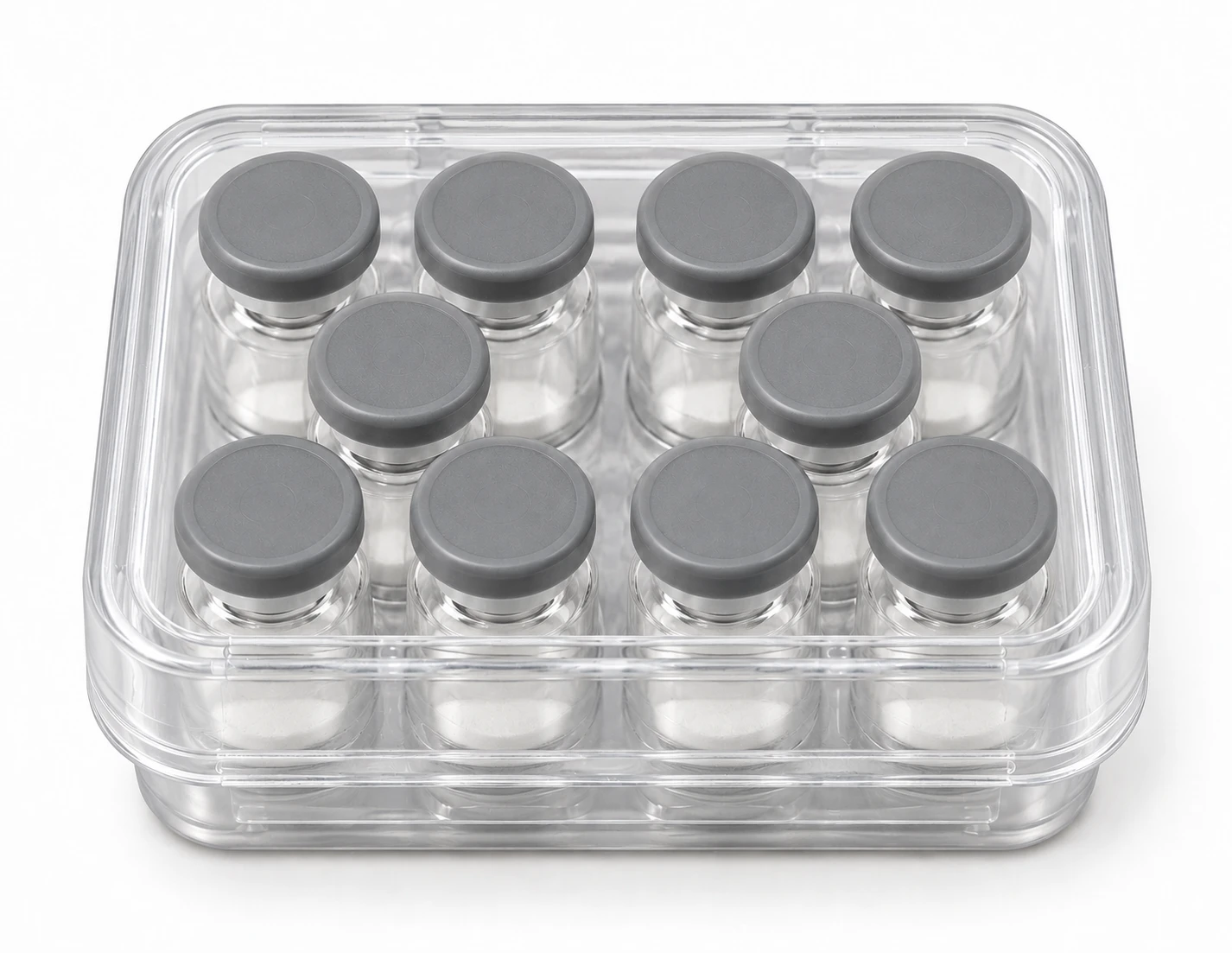Packaging illustration: ten unlabelled glass vials with gray caps in a compact clear plastic kit case with its lid closed